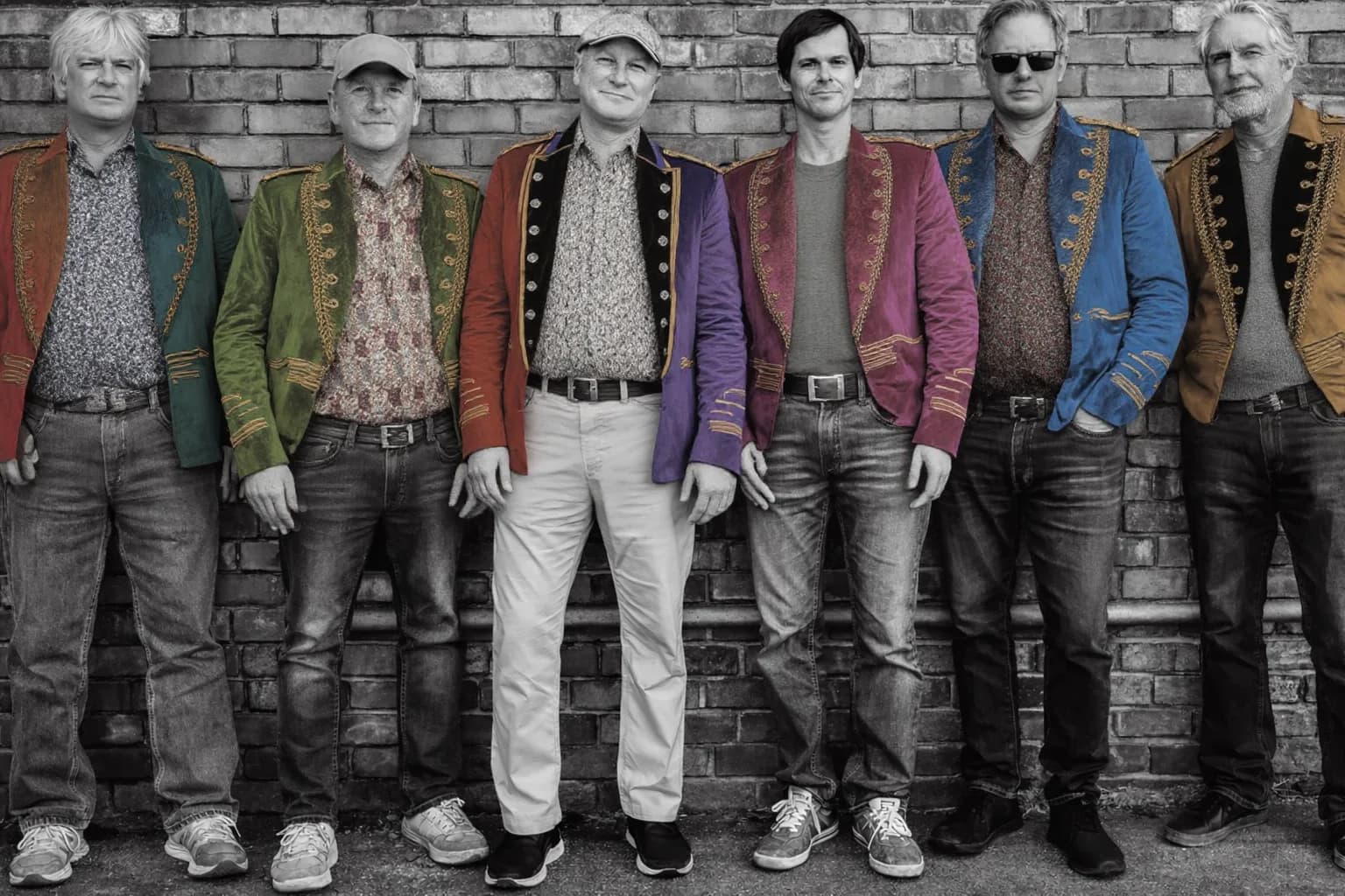 The six members of Nowhere Men in colorful Sgt. Pepper-style jackets